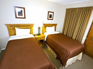 Twin beds in the suites at Tantalus Whistler Lodge